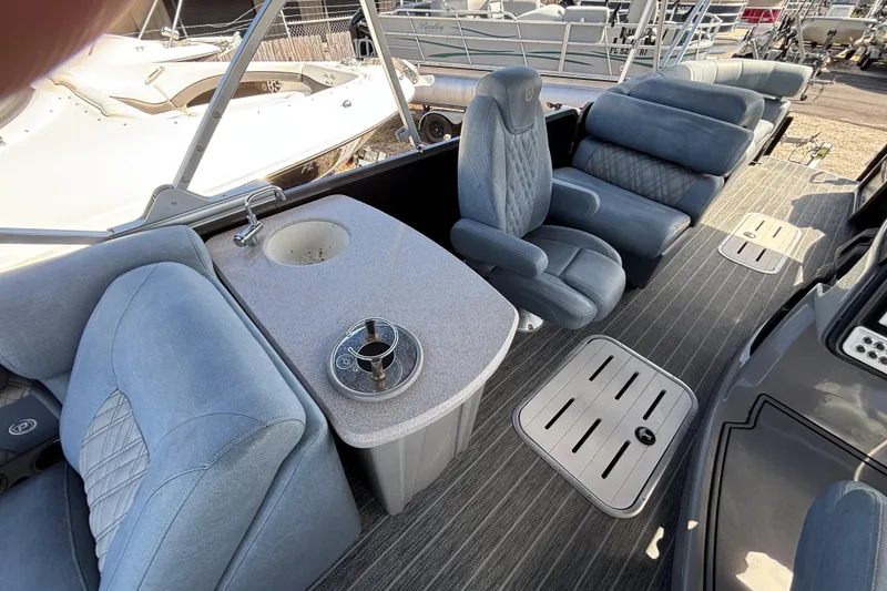 Slide: The Image of Luxurious seating area on 2021 Premier 270 Intrigue RF boat with plush blue upholstery. - 10