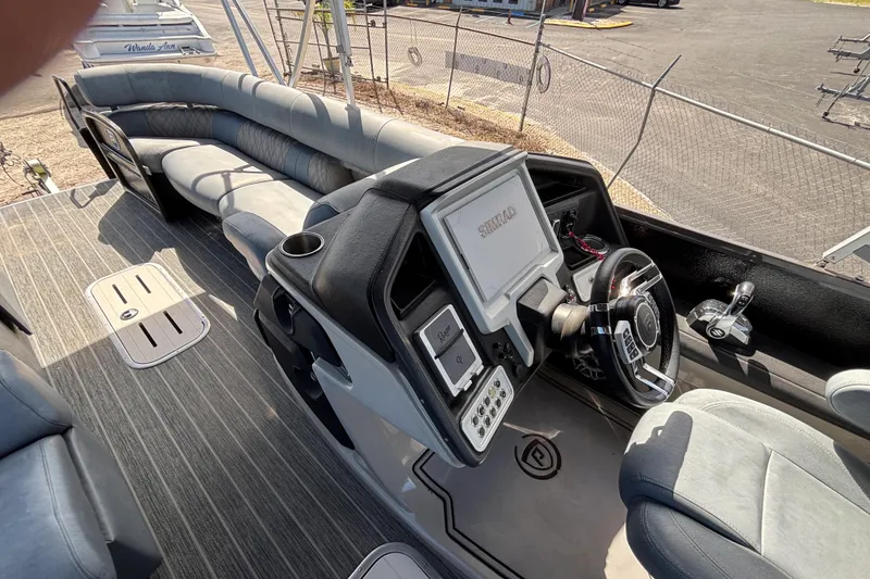 Slide: The Image of 2021 Premier 270 Intrigue RF boat interior with steering console and plush seating. - 14