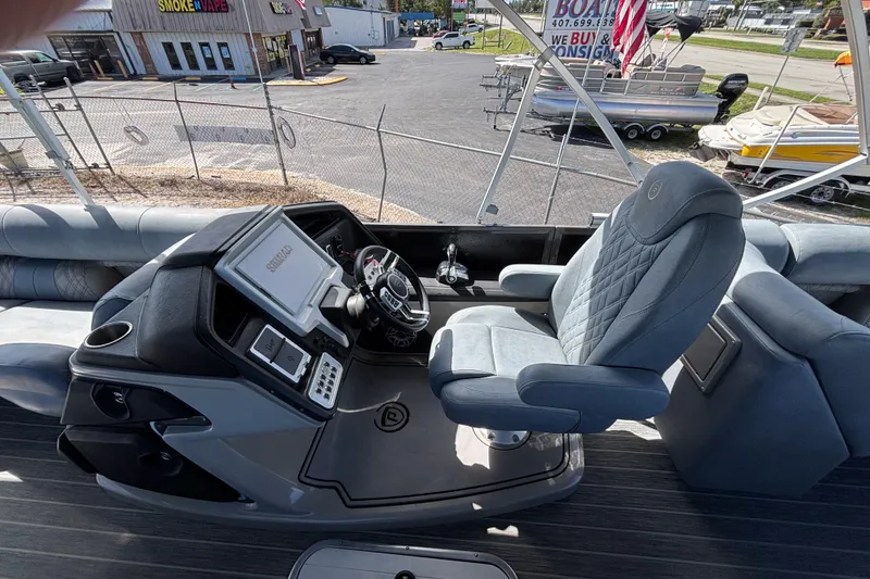 Slide: The Image of Interior of 2021 Premier 270 Intrigue RF boat with captain's chair and control panel. - 15