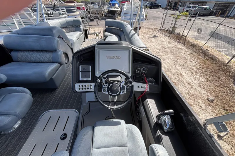 Slide: The Image of 2021 Premier 270 Intrigue RF boat interior with steering console and plush seating. - 16
