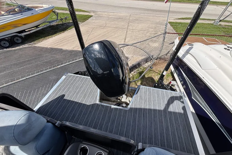 Slide: The Image of 2021 Premier 270 Intrigue RF boat with outboard motor and striped deck flooring. - 23