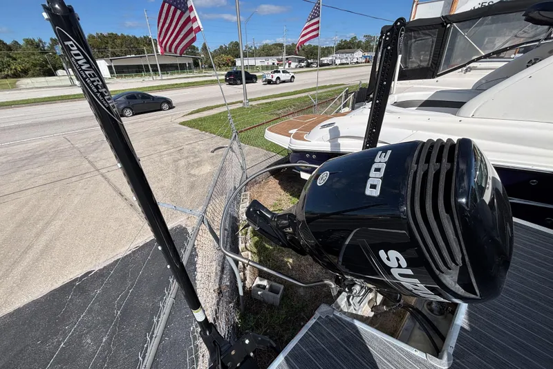 Slide: The Image of 2021 Premier 270 Intrigue RF boat with powerful 300 HP outboard motor, parked near road. - 28