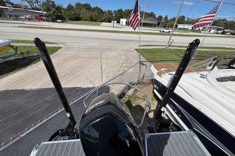 Slide: The Image of 2021 Premier 270 Intrigue RF boat with dual power poles, parked near American flags. - 29