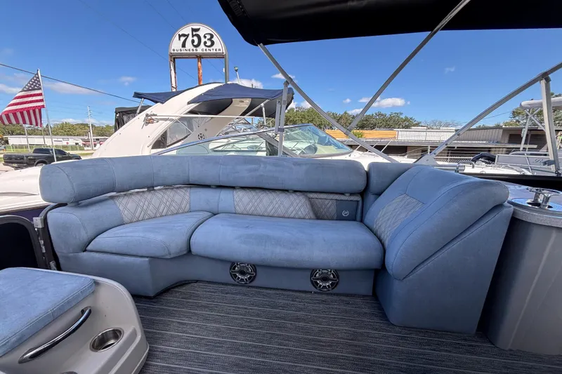 Slide: The Image of Luxurious seating on 2021 Premier 270 Intrigue RF boat, with blue upholstery and American flag in background. - 30
