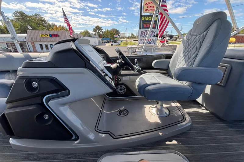 Slide: The Image of 2021 Premier 270 Intrigue RF boat helm with captain's chair and control panel. - 32