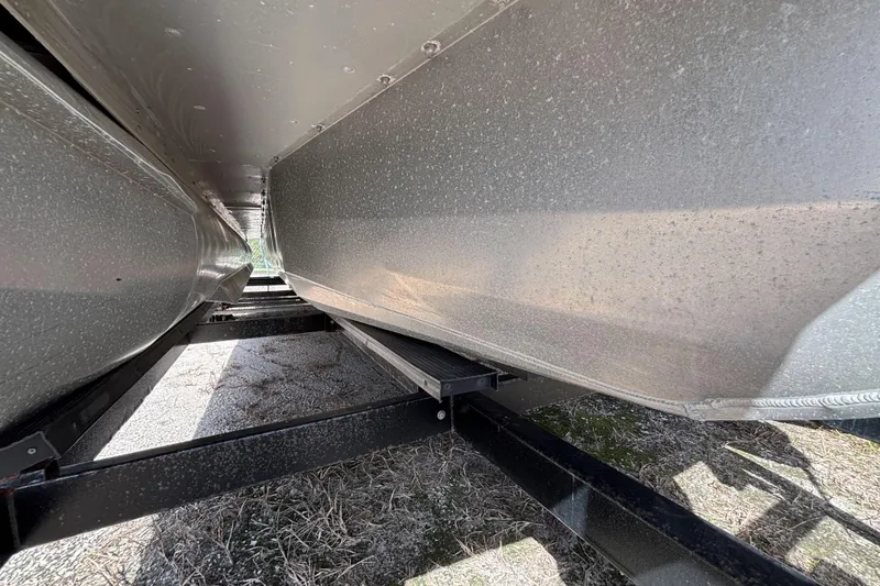 Slide: The Image of Underneath view of a 2021 Premier 270 Intrigue RF pontoon boat on a trailer. - 38