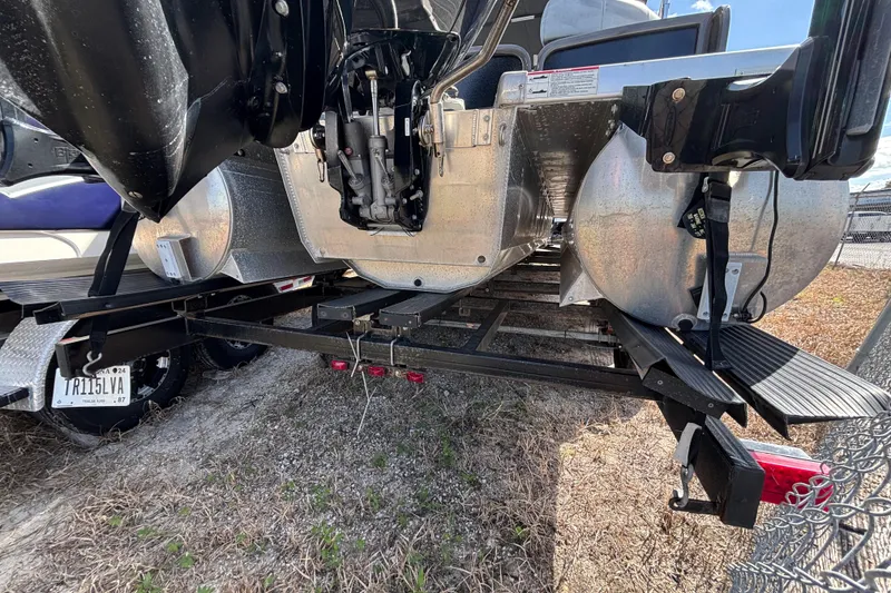 Slide: The Image of 2021 Premier 270 Intrigue RF pontoon boat on trailer, rear view showing engine and pontoons. - 41