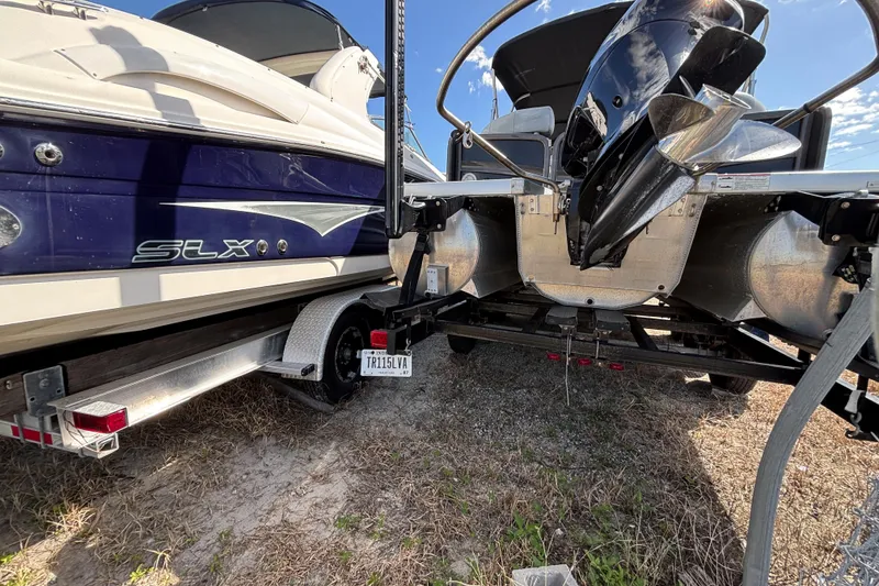 Slide: The Image of 2021 Premier 270 Intrigue RF boat on trailer, parked on grass under clear sky. - 42