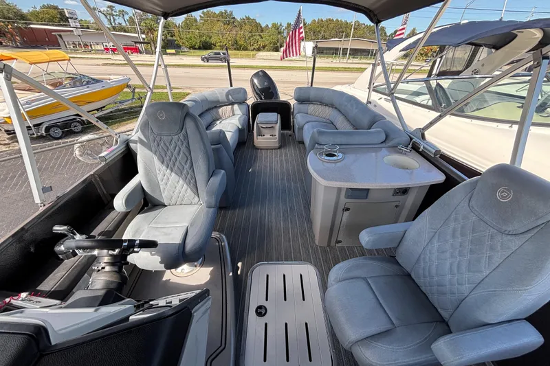 Slide: The Image of 2021 Premier 270 Intrigue RF pontoon boat interior with luxurious seating and helm. - 6