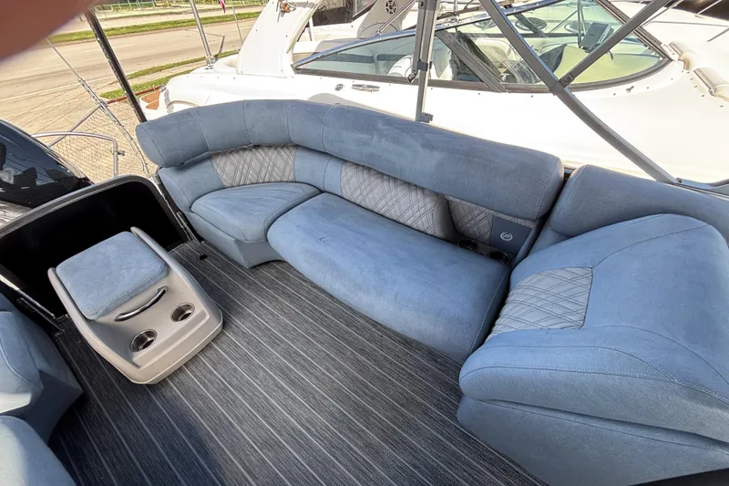 Slide: The Image of 2021 Premier 270 Intrigue RF boat interior with blue seating and cup holders. - 9