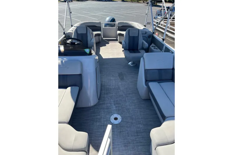 Slide: The Image of 2021 Bennington 22SRX pontoon boat interior with gray seating and spacious layout. - 4