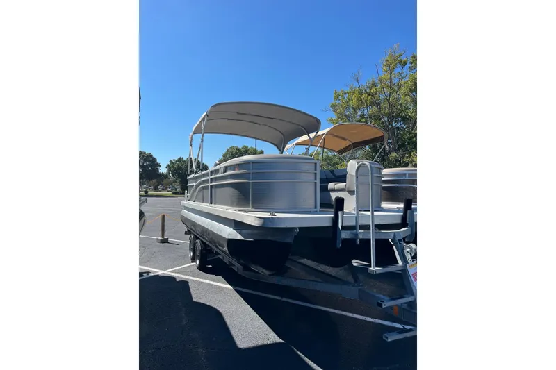 Slide: The Image of 2021 Bennington 22SRX pontoon boat with canopy on trailer in parking lot. - 5