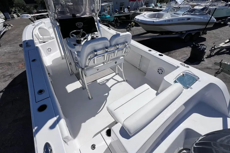 Slide: The Image of 2023 Sportsman Open 242 Center Console boat interior with seating and steering console. - 11