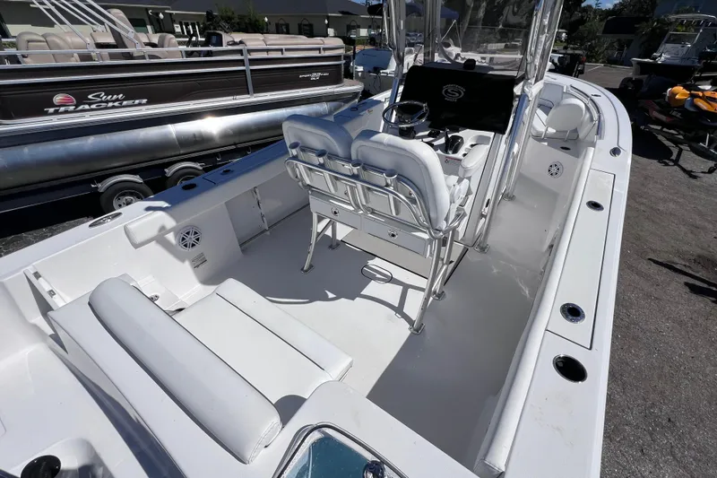 Slide: The Image of 2023 Sportsman Open 242 Center Console boat interior with seating and steering console. - 12
