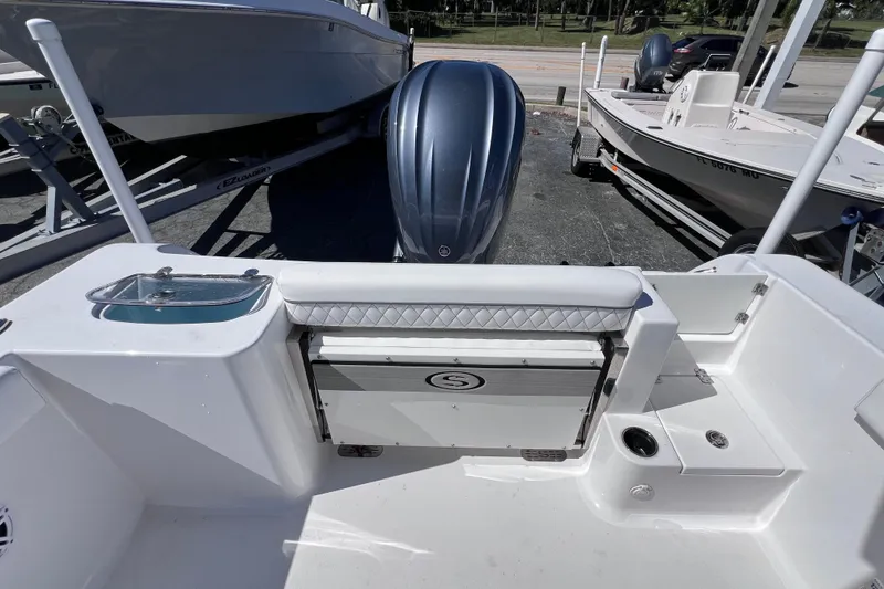 Slide: The Image of 2023 Sportsman Open 242 Center Console boat interior with seating and storage. - 15