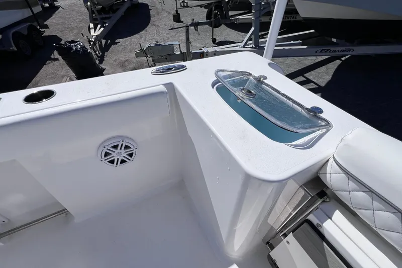 Slide: The Image of 2023 Sportsman Open 242 Center Console boat interior with livewell and speaker. - 16