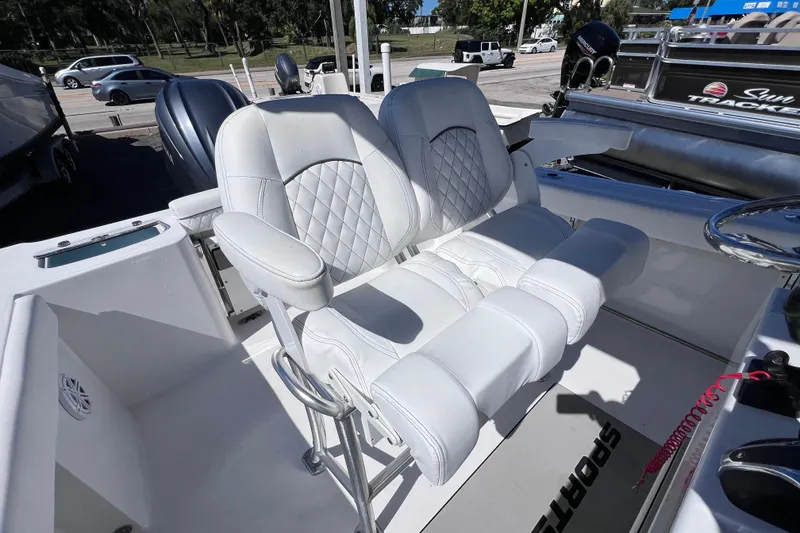 Slide: The Image of 2023 Sportsman Open 242 Center Console with white cushioned seating and steering area. - 19