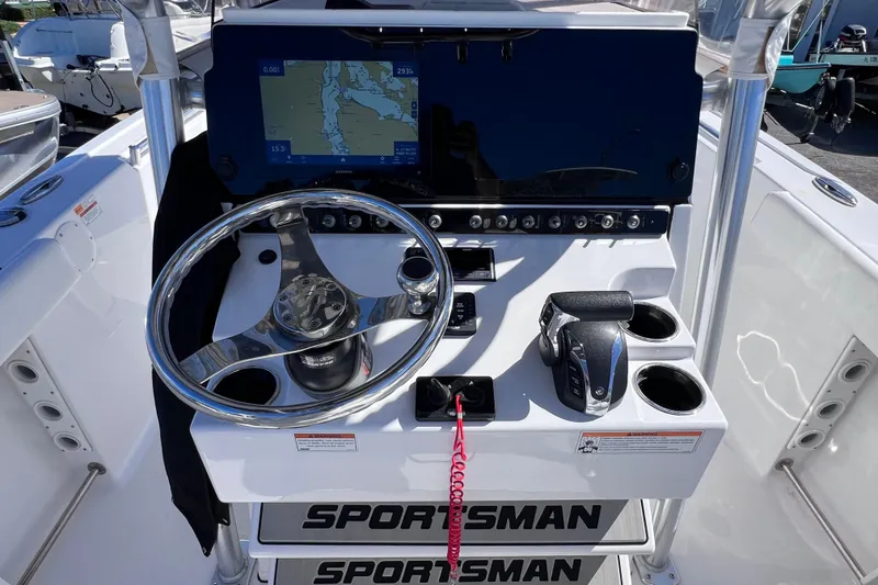 Slide: The Image of 2023 Sportsman Open 242 Center Console dashboard with steering wheel and navigation display. - 21