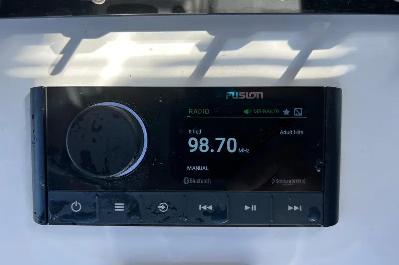 Slide: The Image of Fusion marine radio display on a 2023 Sportsman Open 242 Center Console boat. - 23