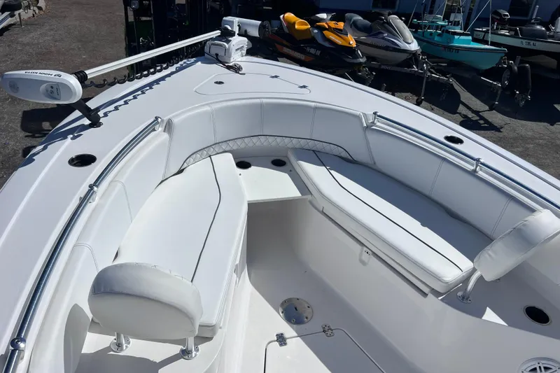 Slide: The Image of 2023 Sportsman Open 242 Center Console boat with white seating and sleek design. - 32