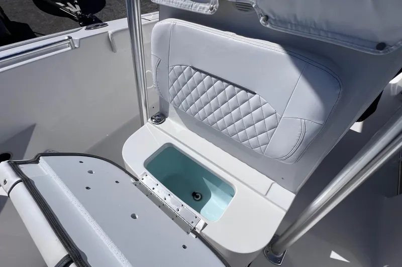 Slide: The Image of 2023 Sportsman Open 242 Center Console boat seat with storage compartment. - 38