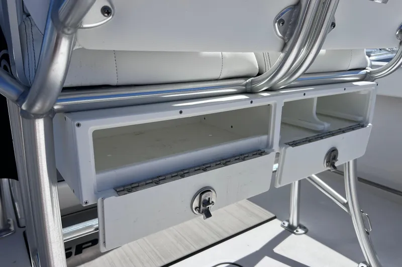 Slide: The Image of 2023 Sportsman Open 242 Center Console storage compartments with secure locks. - 41