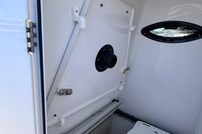 Slide: The Image of 2023 Sportsman Open 242 Center Console interior with hatch and porthole. - 47