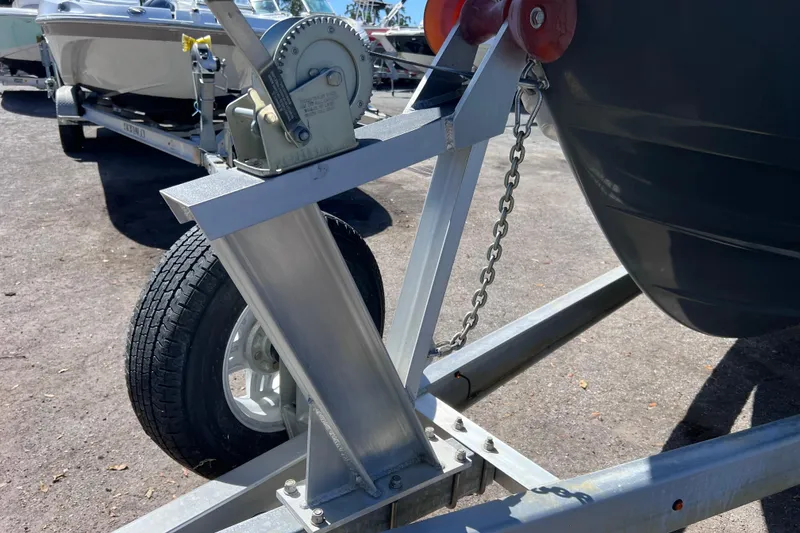 Slide: The Image of 2023 Sportsman Open 242 Center Console boat on trailer, close-up of winch and wheel. - 51