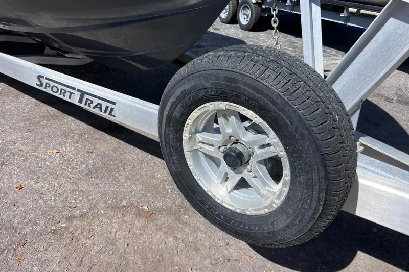 Slide: The Image of Trailer wheel of 2023 Sportsman Open 242 Center Console on Sport Trail trailer. - 54