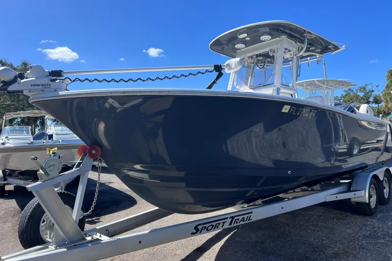 Slide: The Image of 2023 Sportsman Open 242 Center Console boat on trailer under clear blue sky. - 7