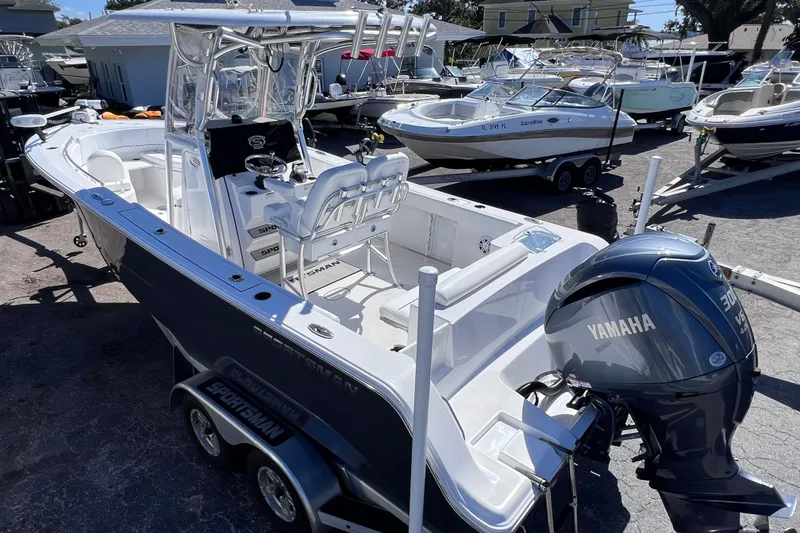 Slide: The Image of 2023 Sportsman Open 242 Center Console boat with Yamaha engine in a marina. - 9