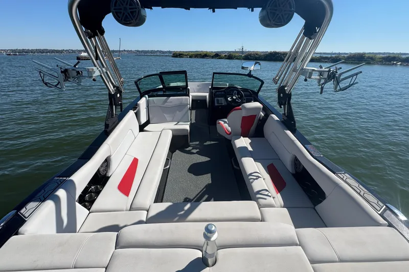 Slide: The Image of 2021 MasterCraft NXT24 boat interior with spacious seating on a sunny day. - 24