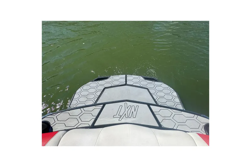 Slide: The Image of 2021 MasterCraft NXT24 boat platform on water, showcasing hexagonal design. - 25