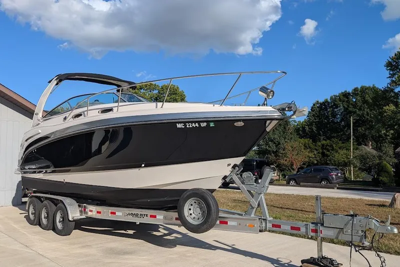Slide: The Image of 2016 Chaparral 290 Signature boat on trailer under blue sky. - 1