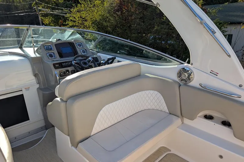 Slide: The Image of 2016 Chaparral 290 Signature boat interior with steering wheel and seating area. - 10