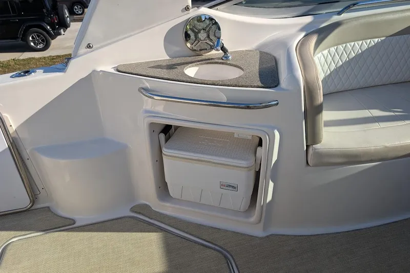 Slide: The Image of 2016 Chaparral 290 Signature boat interior with sink and cooler storage. - 11