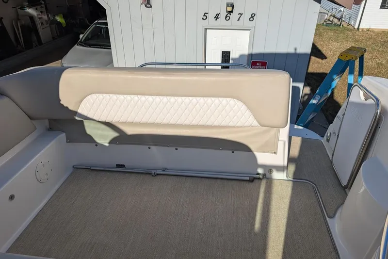 Slide: The Image of 2016 Chaparral 290 Signature boat interior with beige seating and carpeted flooring. - 13