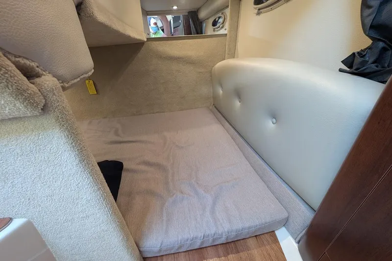 Slide: The Image of 2016 Chaparral 290 Signature cabin interior with cushioned sleeping area. - 28