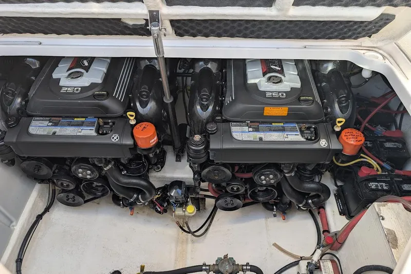 Slide: The Image of Engine compartment of a 2016 Chaparral 290 Signature boat, featuring dual Mercury 250 engines. - 31