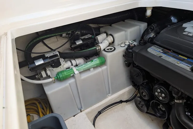 Slide: The Image of Engine compartment of 2016 Chaparral 290 Signature boat, showcasing mechanical components. - 32