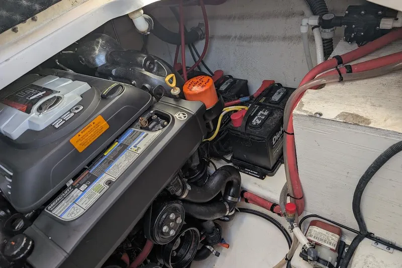 Slide: The Image of Engine compartment of a 2016 Chaparral 290 Signature boat with visible batteries and wiring. - 33