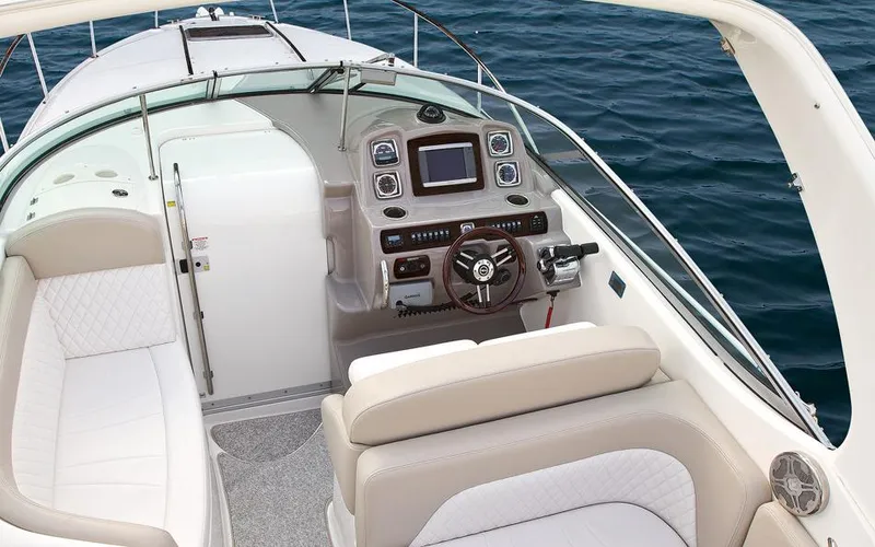 Slide: The Image of Manufacturer Provided Image: 2016 Chaparral 290 Signature boat cockpit with steering wheel and seating, on water. - 40