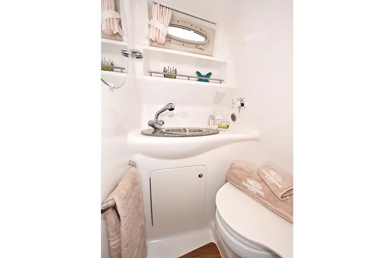 Slide: The Image of Manufacturer Provided Image: 2016 Chaparral 290 Signature boat bathroom with sink, toilet, and storage shelves. - 49