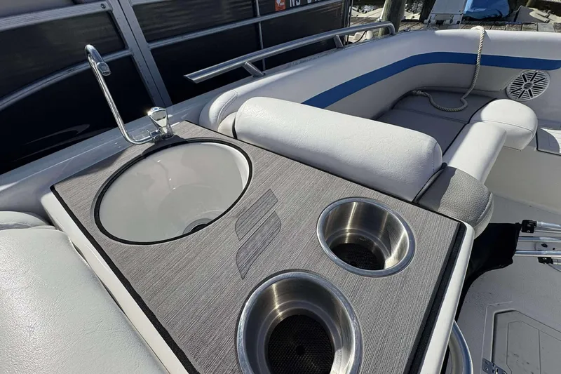 Slide: The Image of 2022 Starcraft Crossover 211 SCX OB boat interior with sink and cup holders. - 11