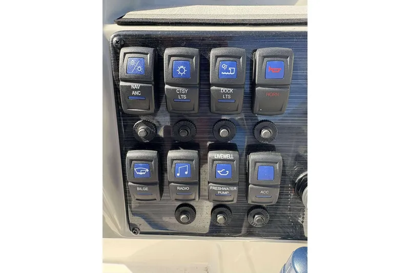 Slide: The Image of Control panel of 2022 Starcraft Crossover 211 SCX OB boat with various switches. - 12