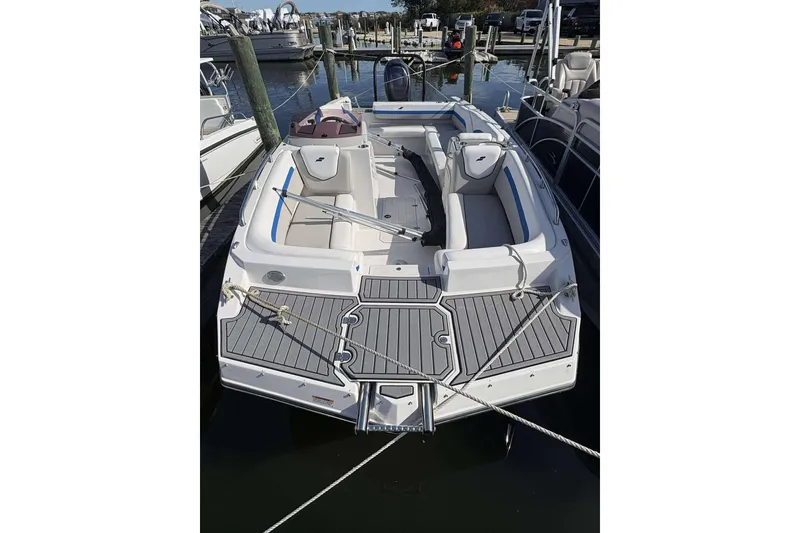 Slide: The Image of 2022 Starcraft Crossover 211 SCX OB boat docked at marina, featuring spacious seating. - 3