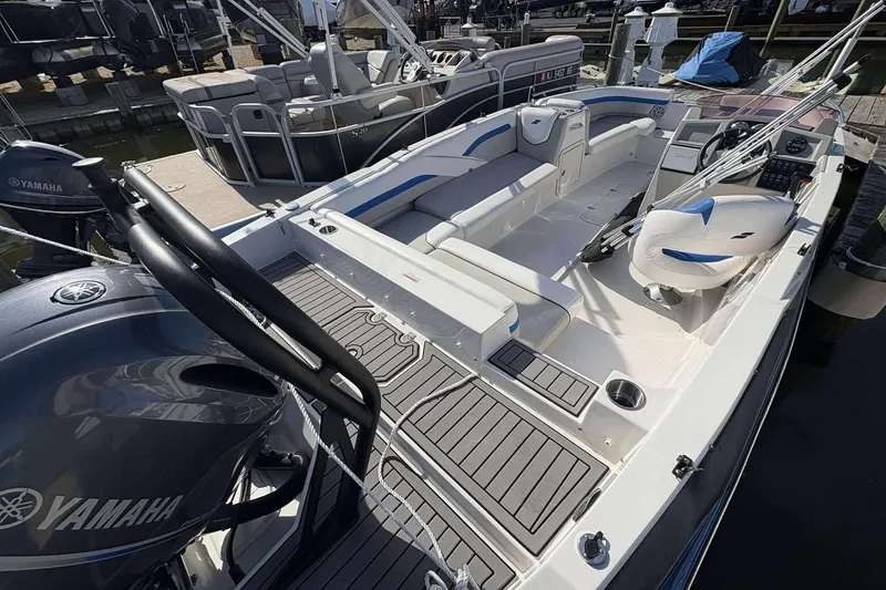 Slide: The Image of 2022 Starcraft Crossover 211 SCX OB boat interior with Yamaha engine, docked at marina. - 4