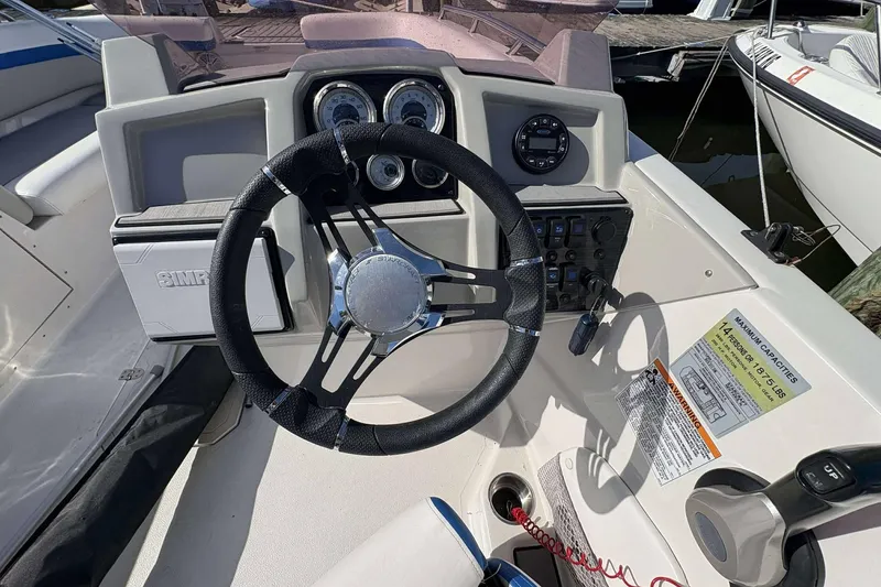 Slide: The Image of 2022 Starcraft Crossover 211 SCX OB boat dashboard with steering wheel and controls. - 9