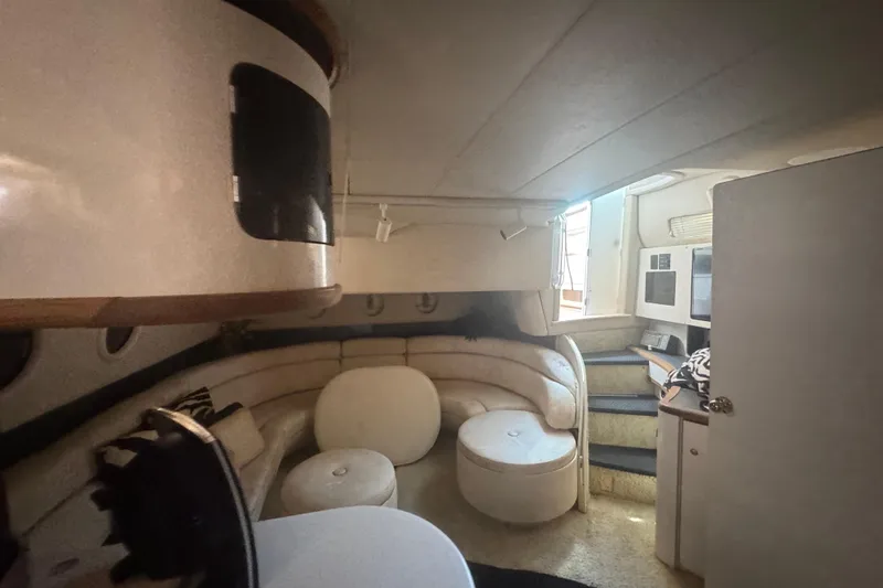 Slide: The Image of Interior of a 1995 Sea Ray 500 Sundancer yacht with cozy seating area. - 10