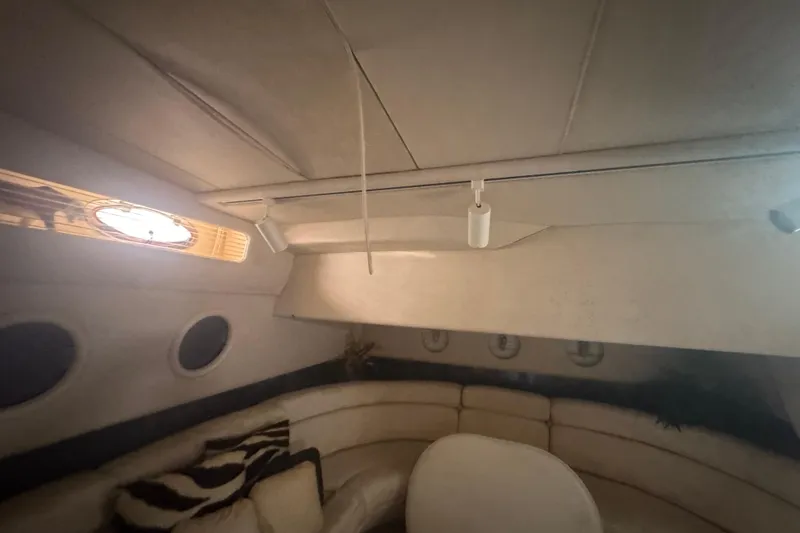 Slide: The Image of Interior of 1995 Sea Ray 500 Sundancer yacht with cozy seating and porthole windows. - 12
